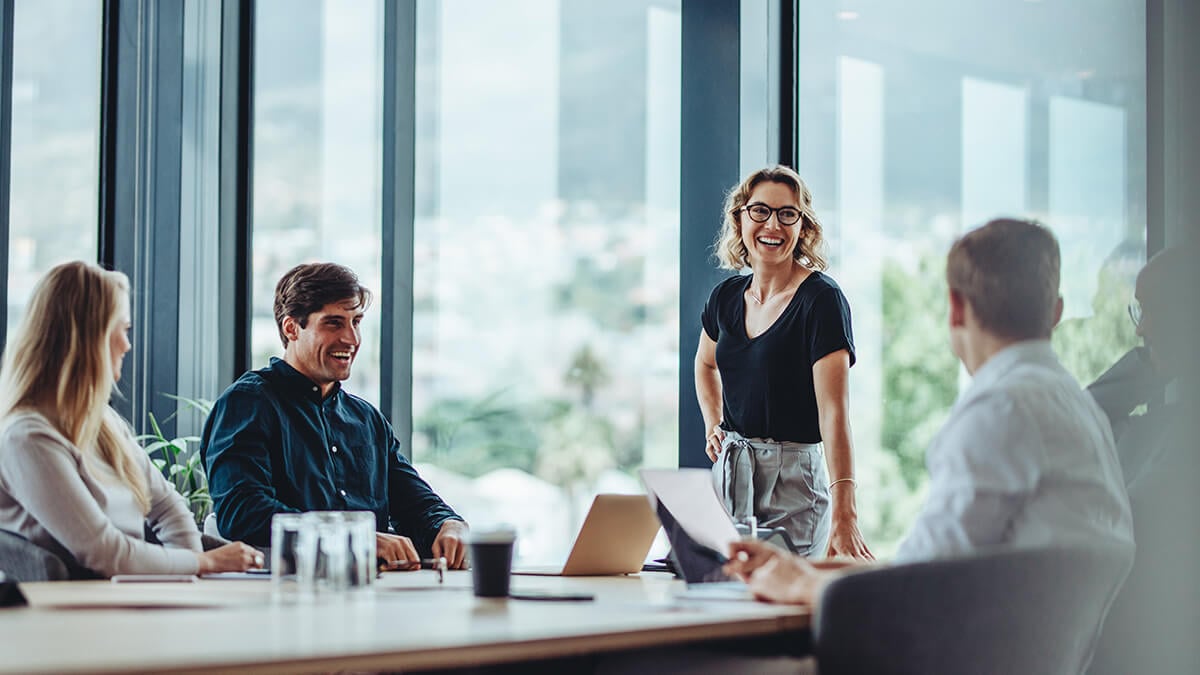 Four employees in a meeting room.