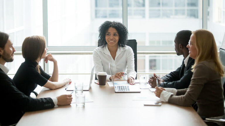 S Corp shareholders at a table talking.