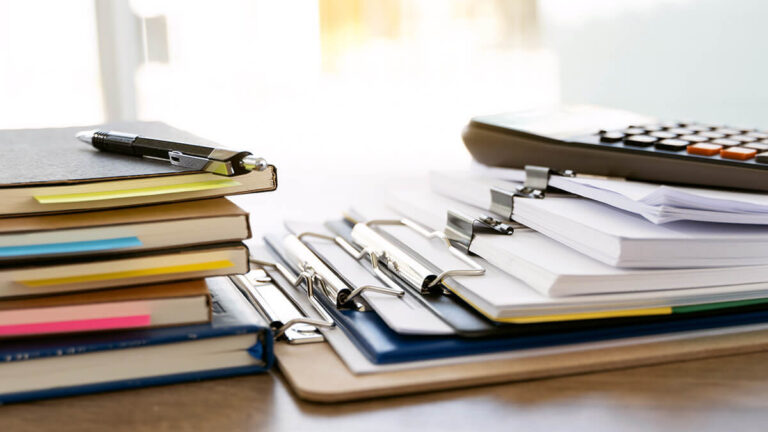 Stack of clipboards and notebooks.