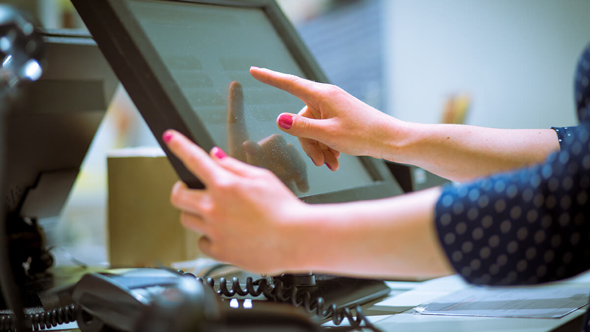 Woman using a touchscreen monitor.