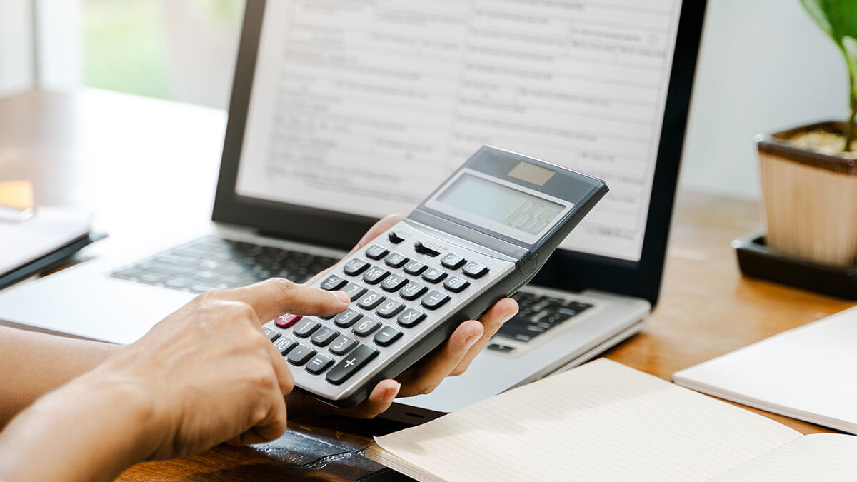 Person using a calculator at a desk.
