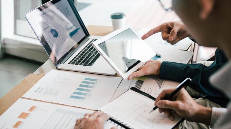 Financial statements spread across a table.