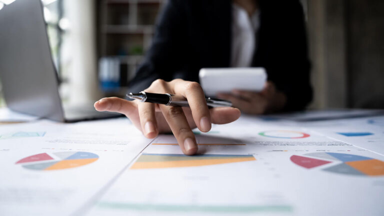 Business owner looking at pie charts.