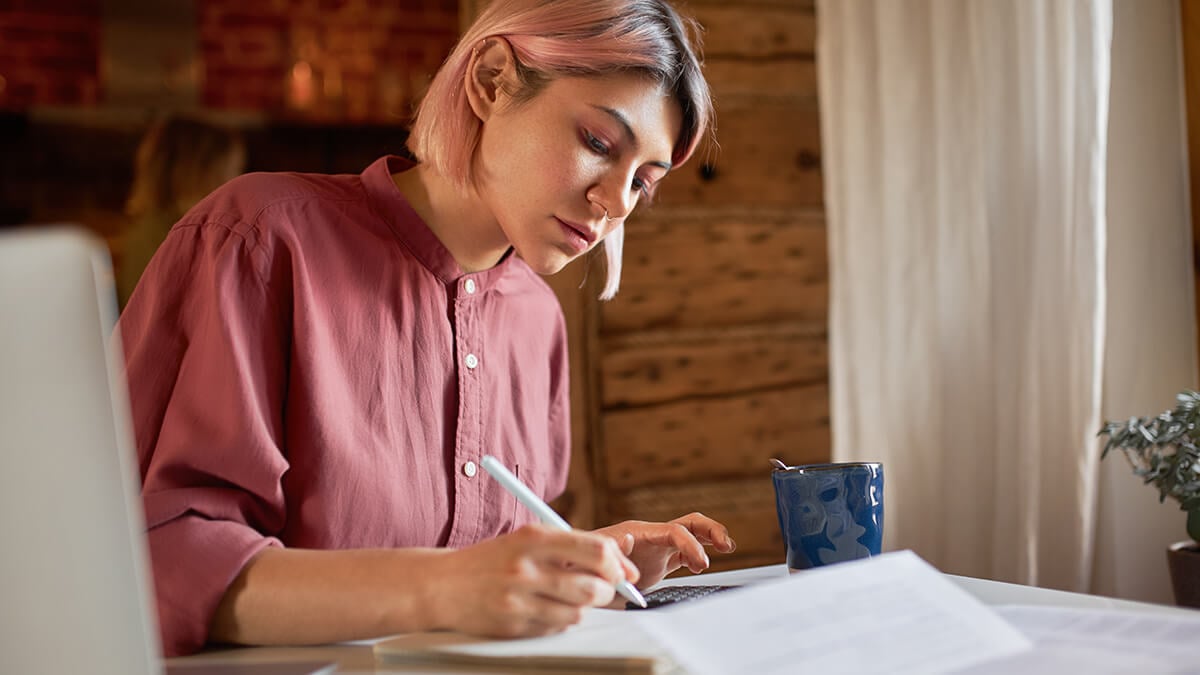 Woman writing on paper.