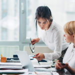 Two women talking in the office.