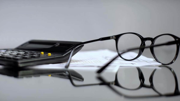 Glasses, calculator, and paper.