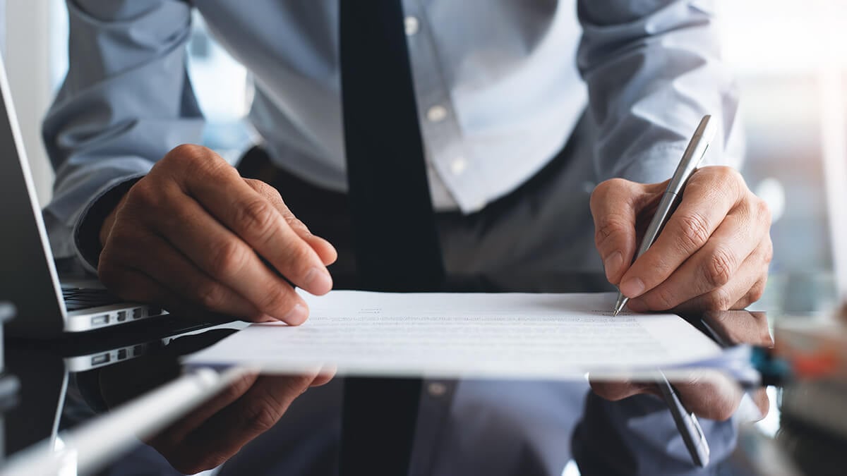 Man filling out accounting forms.