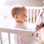 Baby playing with dad's face.