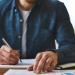 Man filling out paperwork.