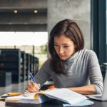 Woman filling out paperwork.