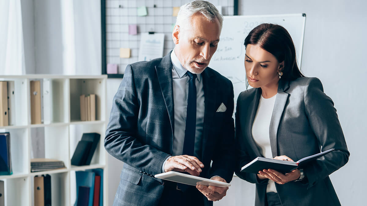 Man and woman discussing risk-adjusted returns.