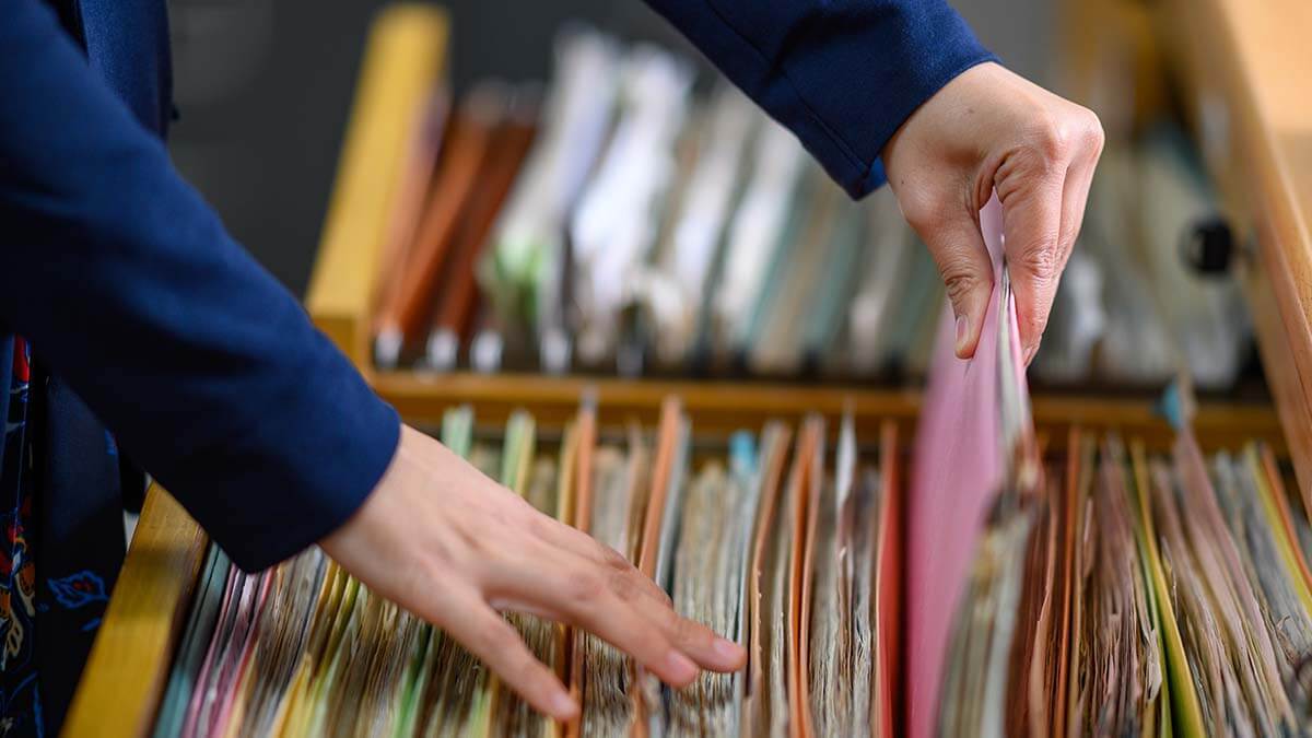 Employer filling documents in a cabinet.