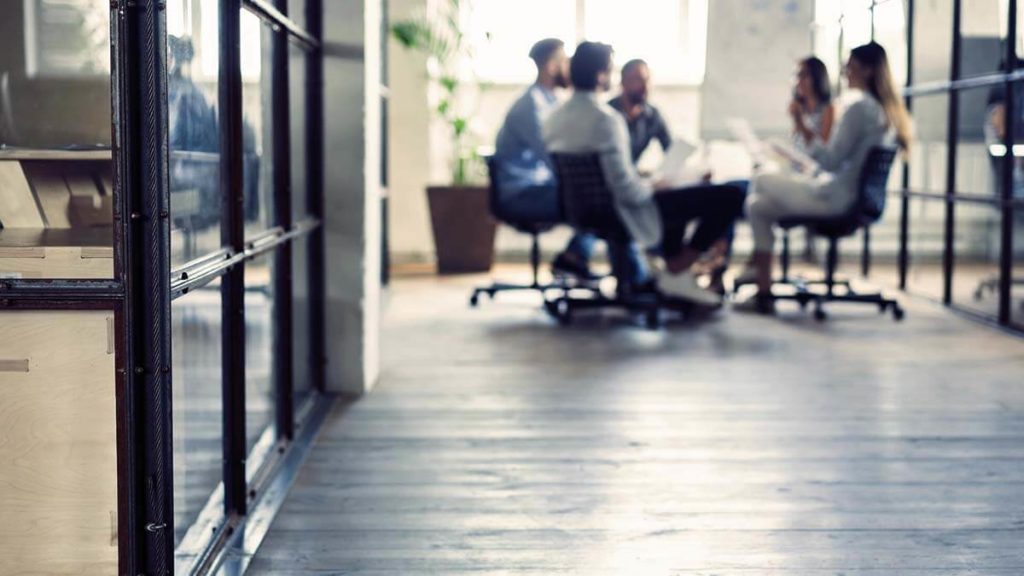 Employees sitting around a table.