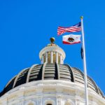 Government building flying the American and California flags.
