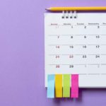 Hanging calendar with sticky notes at the bottom.