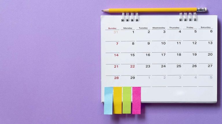 Hanging calendar with sticky notes at the bottom.