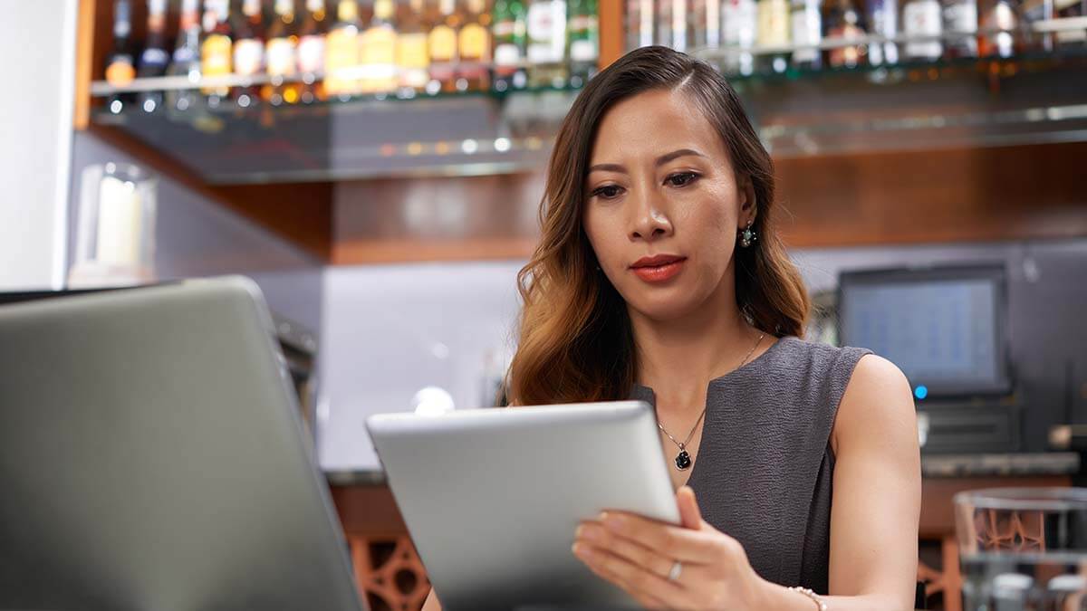 Employer conducting a background check on a tablet.