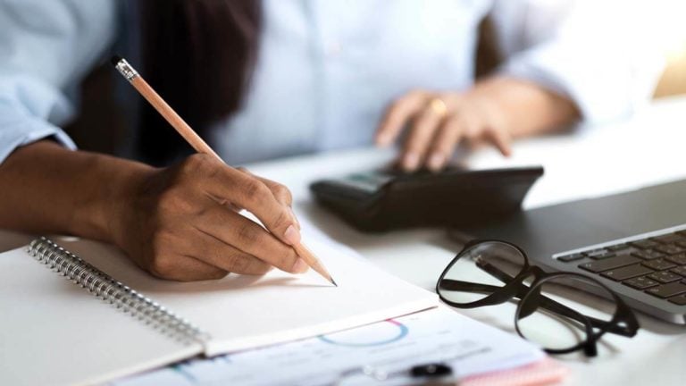 Woman filling out Schedule H.