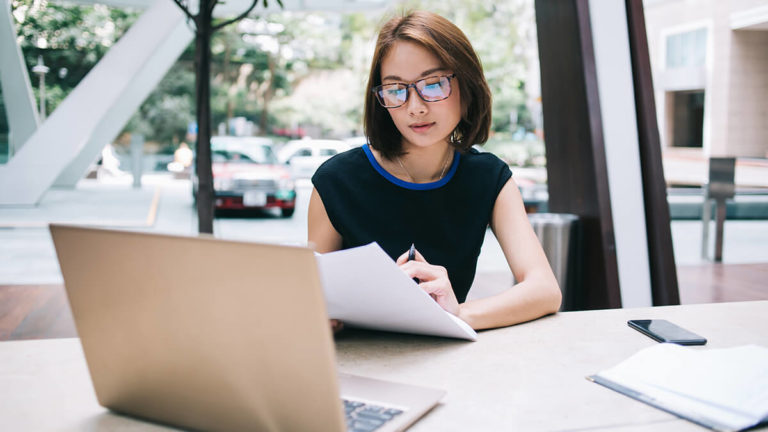 Self-employed woman running payroll.