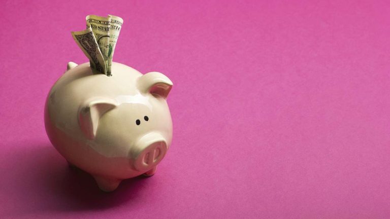 Piggy bank with money sticking out.