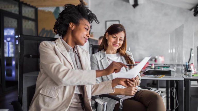 Two co-workers discuss switching payroll companies.