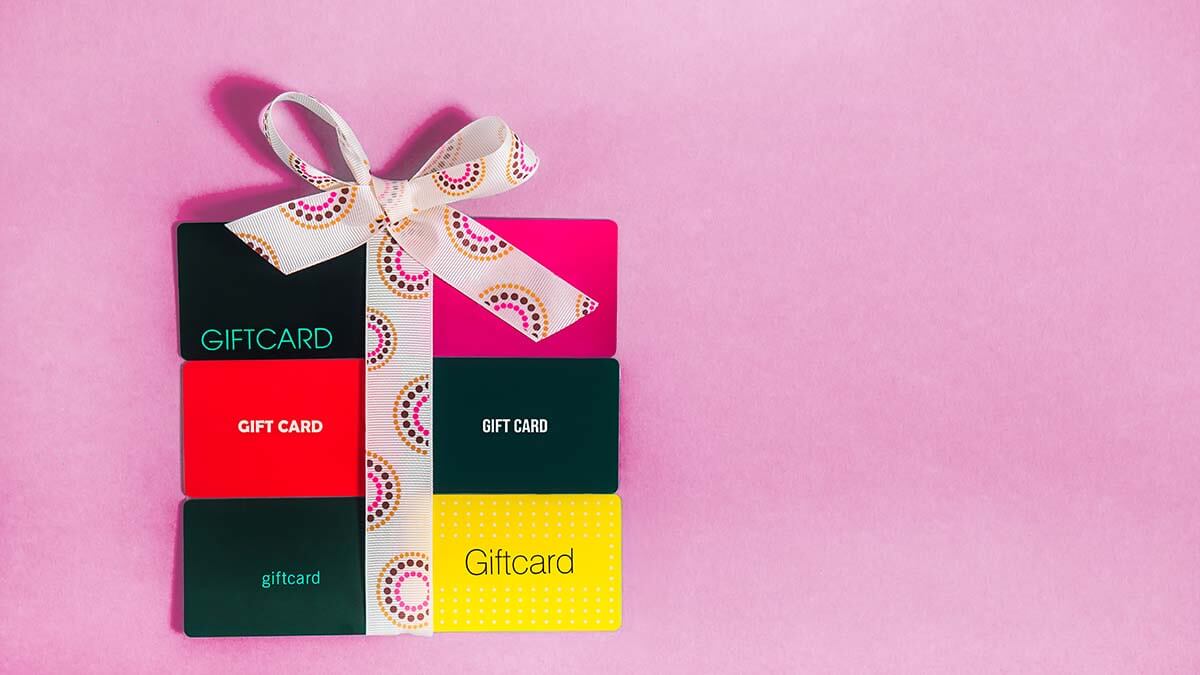 Six gift cards arranged like a package with a bow.