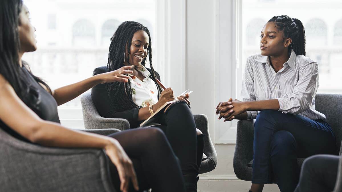 Three women talking.