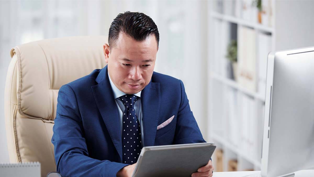 Man in a suit working at a desk.