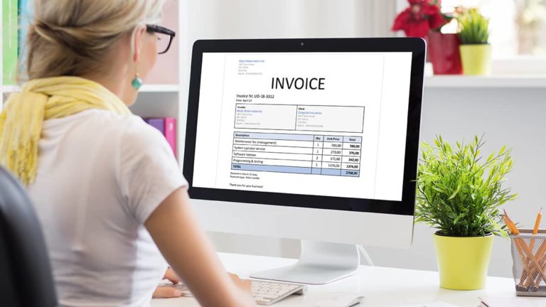 woman on desktop computer generating an e-invoice for customers