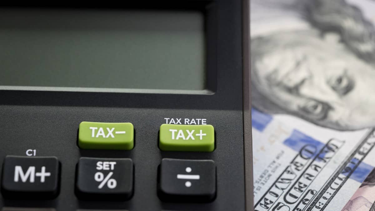 image of a calculator with money behind it