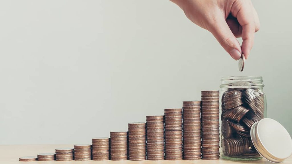 increasing piles of quarters from left to right, ending with a jar of quarters and a person adding more to the jar