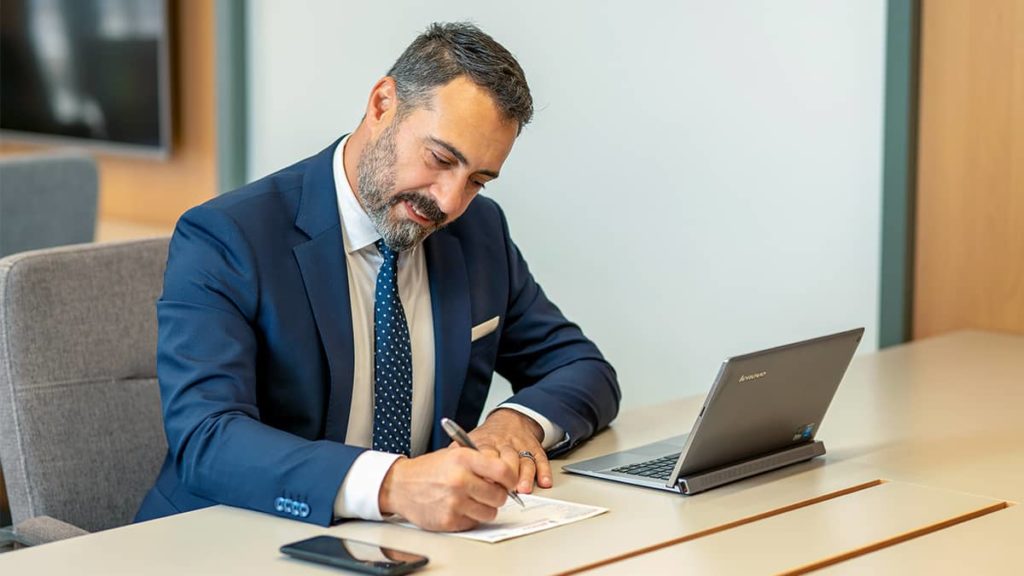 businessman filling out form at his work desk