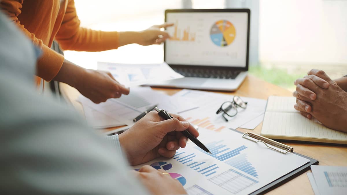 group of individuals reviewing company financial information