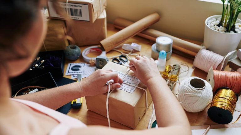 small business owner packages product for customer