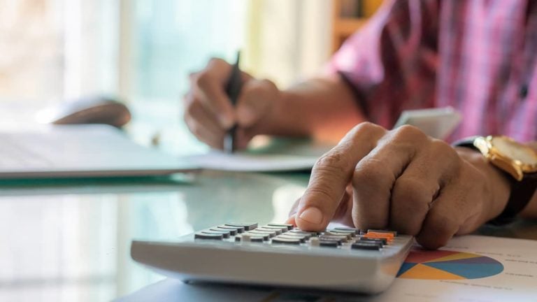 person calculating taxes at a desk