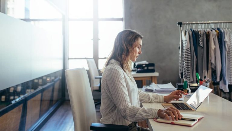 E-commerce business owner working on a laptop.