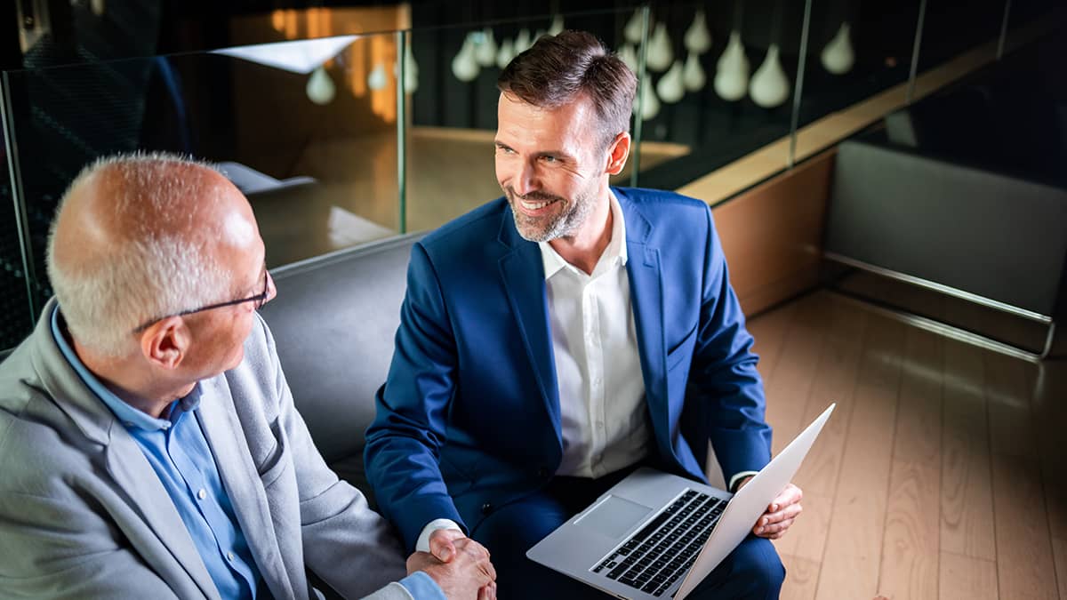 Two men discussing a business merger.