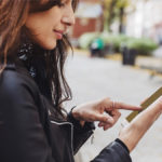 Woman outside using her phone.