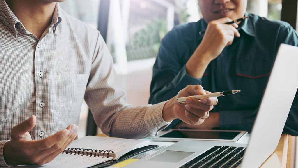 Two co-workers using accounting information for decision-making.