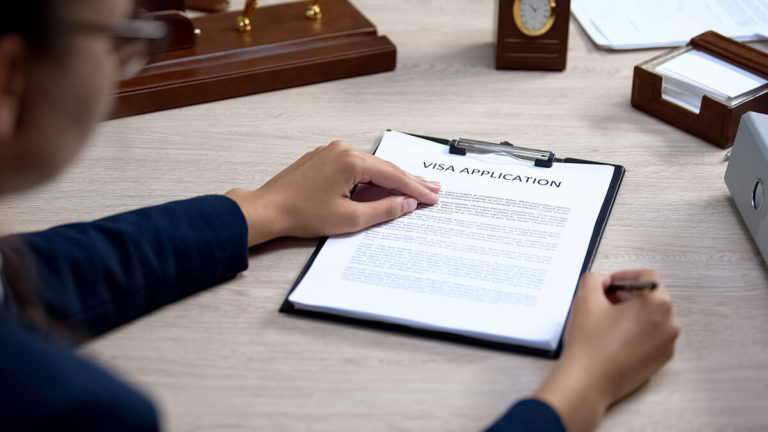 Visa application on a clipboard.