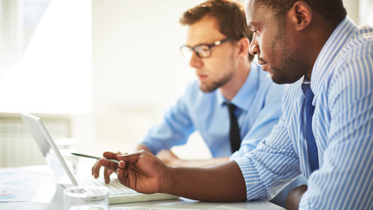 Two men discussing business estimates.