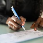 Employer writing out a paycheck.