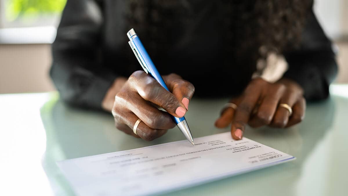 Employer writing out a paycheck.