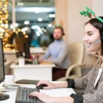Employee with reindeer antlers working over the holidays