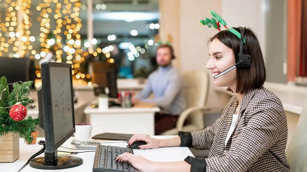 Employee with reindeer antlers working over the holidays