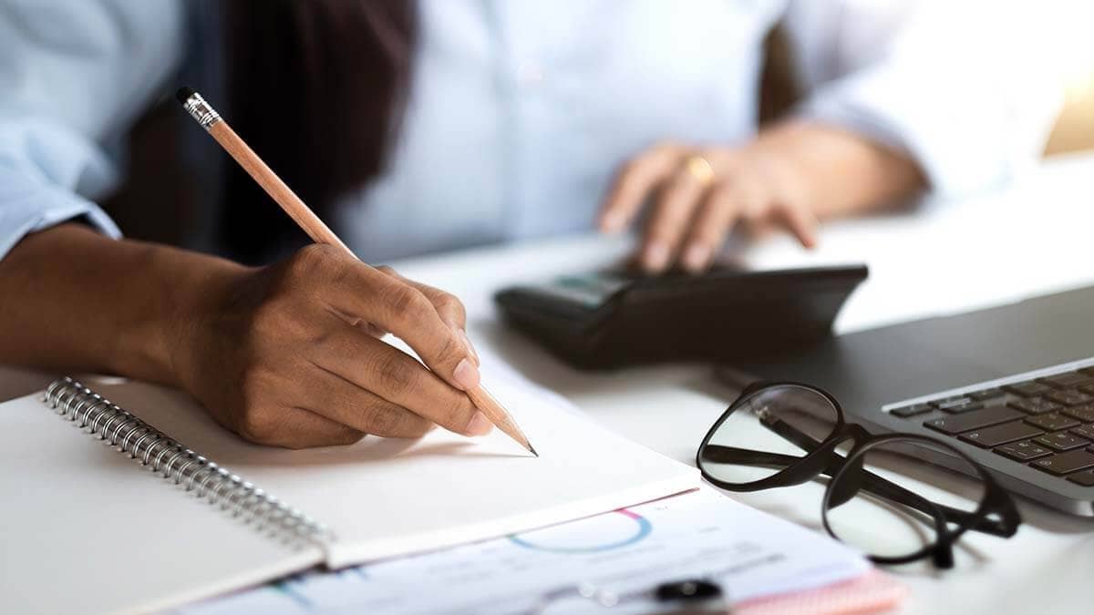 Business owner calculating her budget surplus.