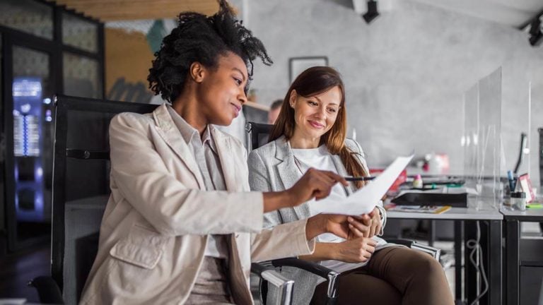 Employer and employee reviewing an employment contract.