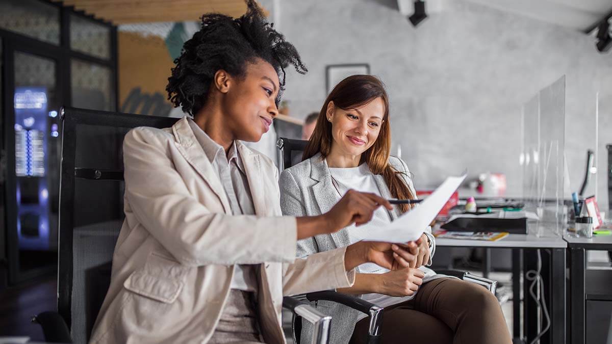 Employer and employee reviewing an employment contract.