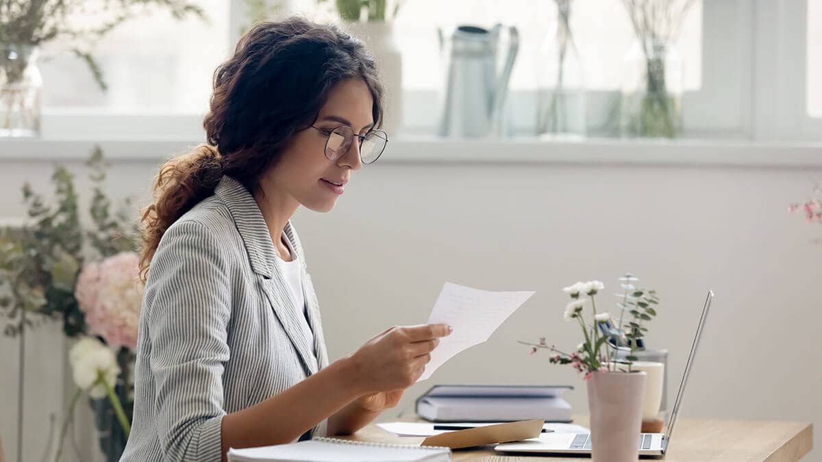 Self-employed woman holding a slip of paper.