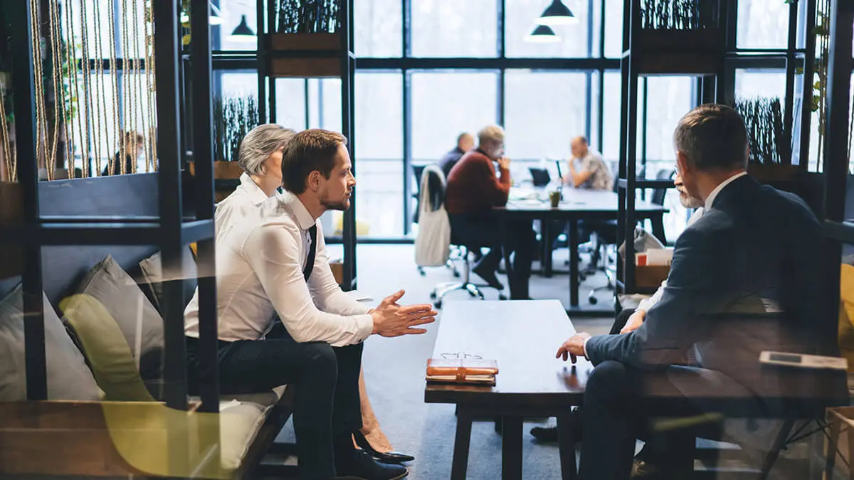 Employees wearing suits in a meeting